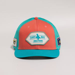 Orange and teal cap with 'Lost Boy Creations' logo 