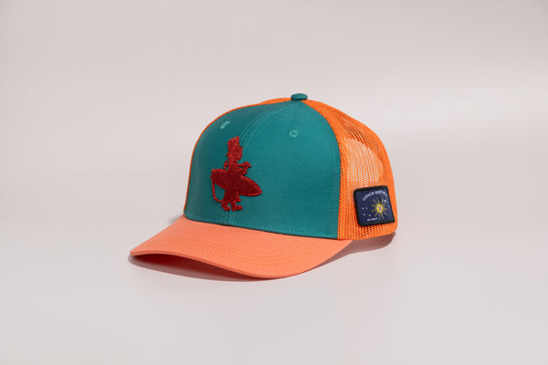 Coral Reefer high crown 6-panel trucker hat side view with Conch Republic flag patch orange brim and orange mesh back | Lost Boy Creations Key West