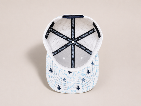 LBC Golf Hat in White — under brim detail showing all-over Key West vibe golf pattern matching the LBC Golf Polo | Lost Boy Creations Key West
