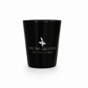 Black shot glass with 'Lost Boy Creations Key West, Florida' text 