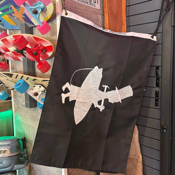 Lost Boy Creations Hoist the Colors flag hanging vertically in shop displaying full embroidered design | Lost Boy Creations Key West