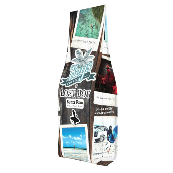 Keys Coffee Company x Lost Boy Creations collaboration coffee bag front view with LBC branding and travel-themed artwork | Lost Boy Creations Key West