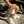 Person holding Lost Boy Creations ceramic mug left handle facing out on a picnic table lifestyle shot | Lost Boy Creations Key West