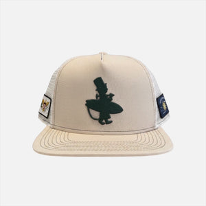 Forest Sand Dunes tan structured trucker hat front view with forest green LBC surfer embroidery USVI and Conch Republic patches on white mesh sides | Lost Boy Creations Key West