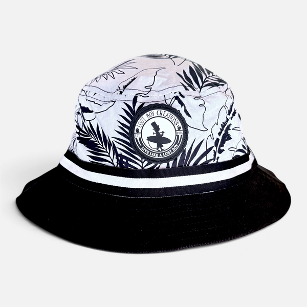 Under Cover Bucket Hat in Black/White — product view, black-and-white tropical leaf print with solid black brim | Lost Boy Creations Key West