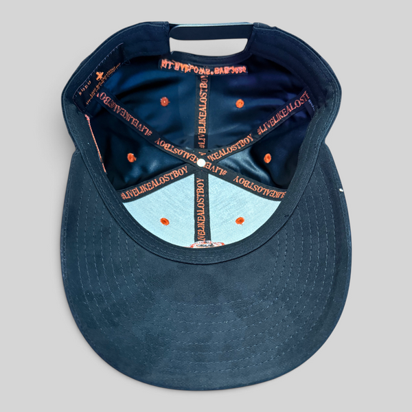 Lost Boy Creations Halloween Hat 2026 in Black — interior view, orange #LIVELIKEALOSTBOY seam tape and black underbrim | Lost Boy Creations Key West