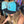 Wave Runner high crown black and aqua hat worn by a woman playing a pinball machine in the Lost Boy Creations store | Lost Boy Creations Key West