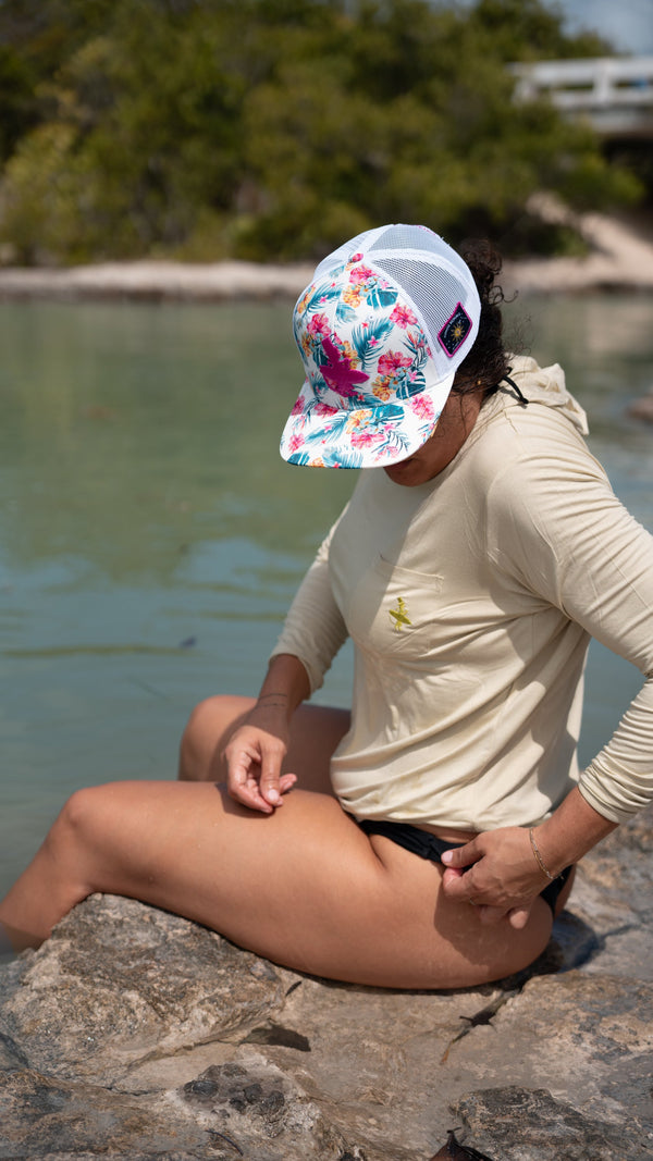 LBC Hooded Sun Shirt tan colorway — lifestyle shot of woman wearing sun shirt on a rock at the bridge | Lost Boy Creations Key West 