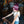 Lost Boy Pom Pom Beanie in Burgundy — lifestyle shot, worn by a child playing pinball in the Lost Boy Creations store | Lost Boy Creations Key West