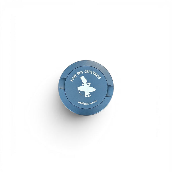 Utility Pocket Tin in Dark Blue — front view, LBC surfer silhouette logo on lid | Lost Boy Creations Key West