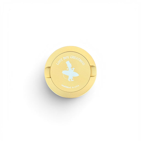 Utility Pocket Tin in Gold — front view, LBC surfer silhouette logo on lid | Lost Boy Creations Key West