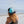 Wave Runner high crown black and aqua hat worn backwards by a woman sitting on the beach looking at the ocean | Lost Boy Creations Key West