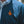 LBC Golf 1/4 Zip navy lifestyle close-up of orange Lost Boy surfer silhouette logo on chest with Key West vibe patterned collar visible | Lost Boy Creations Key West