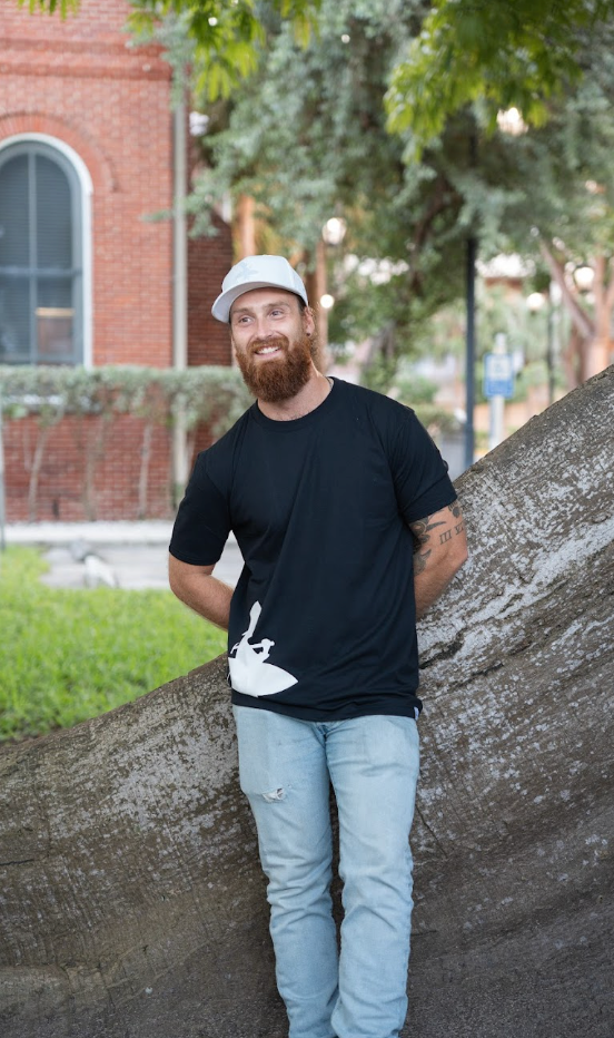 Men's Lost Boy Silhouette Tee in Black — on-model outdoor lifestyle, white Lost Boy silhouette graphic | Lost Boy Creations Key West