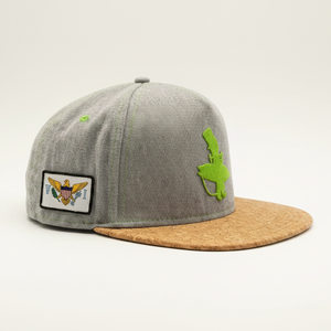 Lime and Cork flat bill snapback hat grey heather crown left side view showing U.S. Virgin Islands flag patch and green Lost Boy surfer logo with natural cork brim | Lost Boy Creations Key West