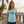 Women's Silver King V-Neck arctic blue lifestyle shot worn by woman at marina with Silver King tarpon graphic | Lost Boy Creations Key West