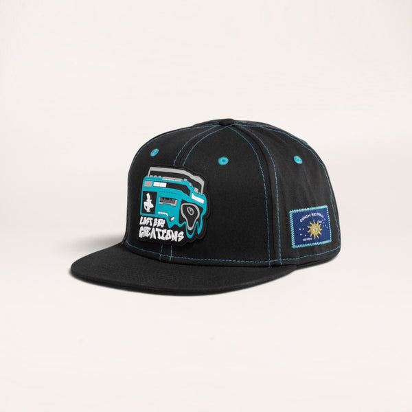 Lost Boy Creations Ghetto Blaster black snapback hat with a boombox rubber patch and blue contrast stitching.