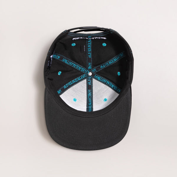 Interior view of a Lost Boy Creations Ghetto Blaster black snapback hat featuring branded teal seam tape.
