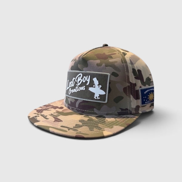 Big Wave Hunter Hat in Camouflage — front flat lay, vintage LBC logo patch with flag patches | Lost Boy Creations Key West