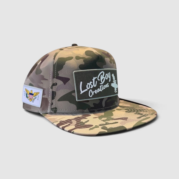 Big Wave Hunter Hat in Camouflage — front view, vintage LBC logo patch with USVI flag side patch | Lost Boy Creations Key West