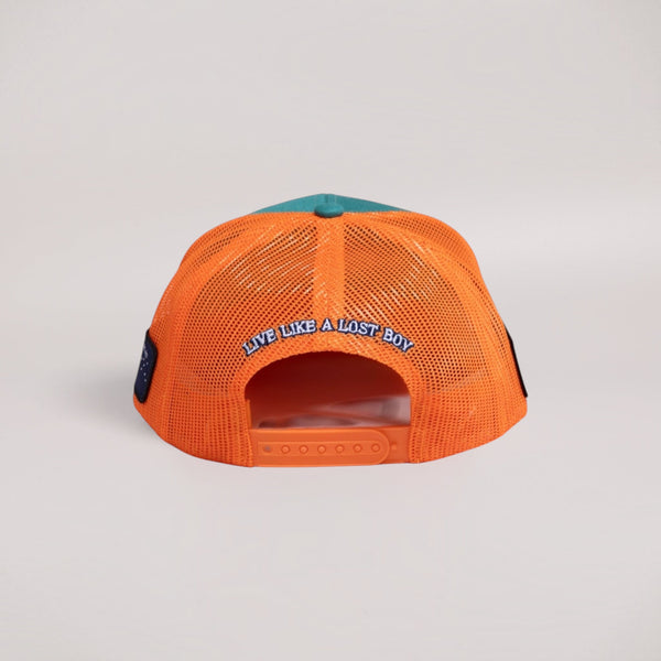 Lost Boy Creations Coral Reefer snapback hat with orange mesh back, teal crown, and Live Like a Lost Boy embroidery.