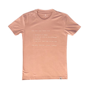 Lost Boy Creations desert pink cotton t-shirt featuring a white definition graphic on the front and hem tag