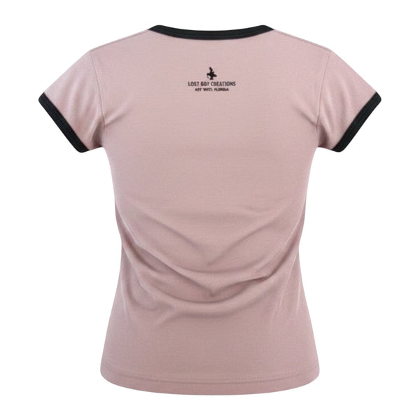 Back view of Lost Boy Creations Desert Pink ringer tee with black contrast neck and sleeve bands and logo detail