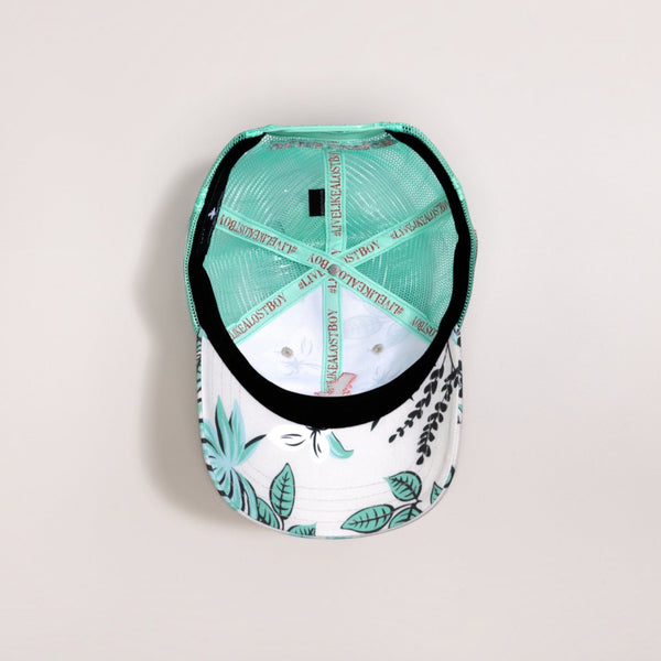 Interior view of Lost Boy Creations Coral Cruiser snapback hat showing seafoam mesh and floral print underbrim.