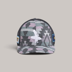 Lost Boy Creations Fuzzy Wuzzy hat with geometric pattern, white logo embroidery, and side patches on a light background