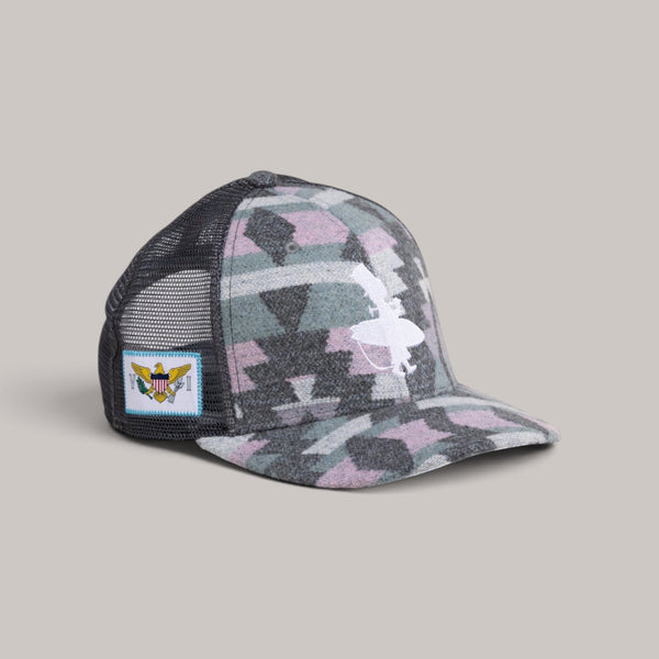 Lost Boy Creations Fuzzy Wuzzy high-crown trucker hat with geometric pattern, mesh back, and USVI flag side patch.