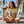 Women's Lost Girl Starfish Tee worn by model seated on coastal porch with surfboards and ocean view in Lemon colorway | Lost Boy Creations Key West