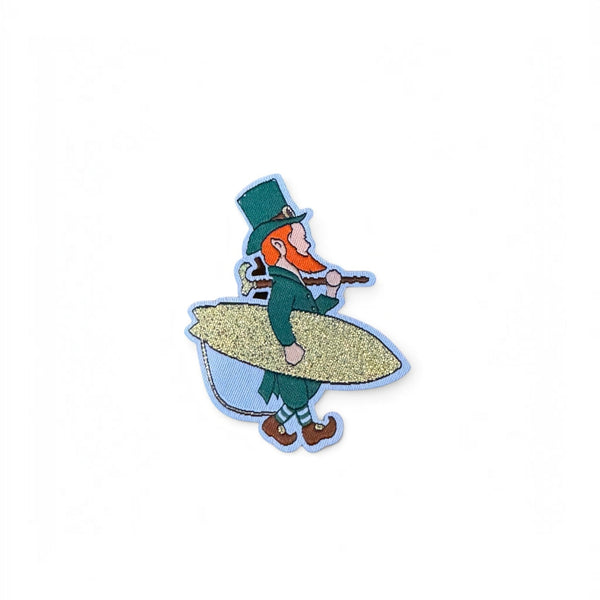 Lost Boy Creations limited edition embroidered St. Patrick's Day patch featuring a leprechaun carrying a surfboard
