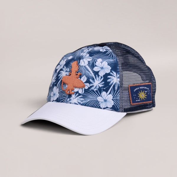 Lost Boy Creations Lei'd Back navy floral trucker hat with white brim, orange logo, and mesh back panels.