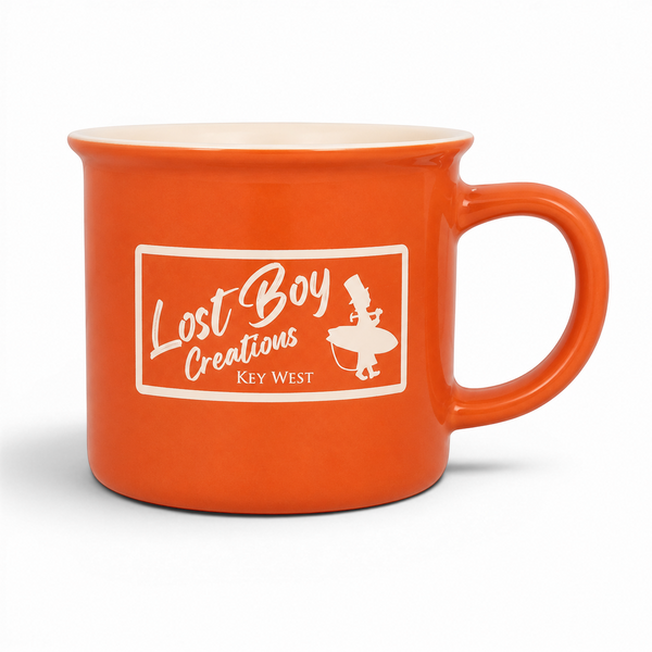 Lost Boy Creations orange ceramic campfire mug with a cream interior and a retro Key West logo on the front.