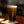 Lost Boy Creations Perfect Pint glass filled with dark beer and foam on a wooden bar top showing Lost Boy Creations logo | Lost Boy Creations Key West