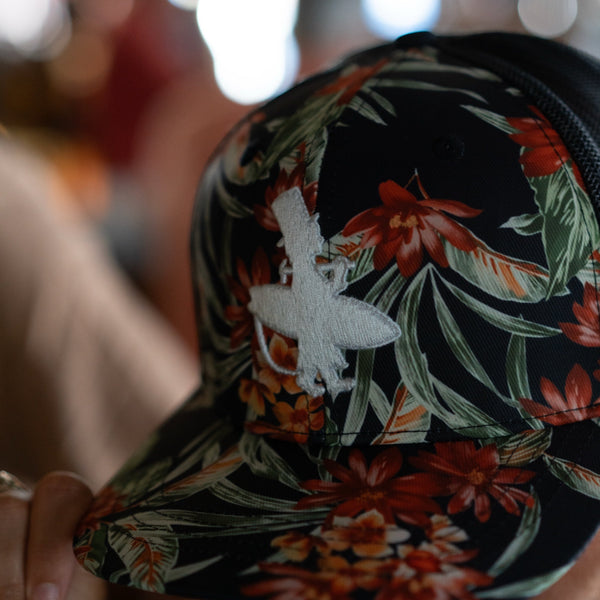 Lost Boy Creations Tarzan snapback hat featuring a bold tropical floral print and white embroidered logo