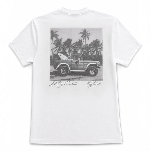 Lost Boy Creations white Bronco Tee 2.0 featuring a black and gray graphic of a vintage SUV with a surfboard on back
