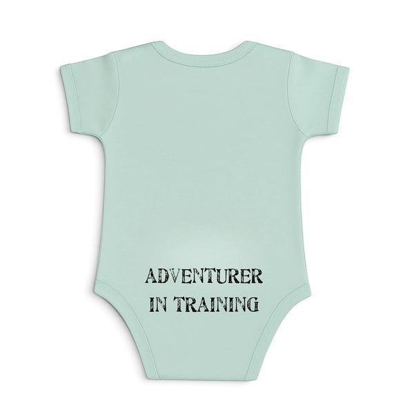 Kid's Lost Boy in Training Onesie in Fern — back view, black "Adventurer in Training" print on green baby bodysuit | Lost Boy Creations Key West
